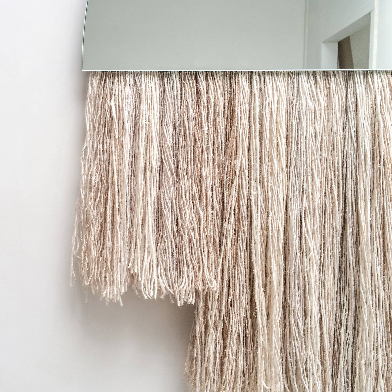The Half Moon mirror by Ben and Aja Blanc combines the functionality of a large sized mirror with the depth and textural interest of sculptural fiber.

6-10 week production lead time.