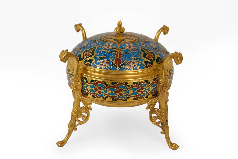 Decorative Box in Champleve enamel  and gilded bronze.
Engraved signature: 'F. Barbedienne' on the body of the box.
H : 13 cm / 5.1 in.
L : 20 cm / 7.9 in.
Diameter of the body : 14,3 cm / 5.5 in.

This box was presented at the Universal