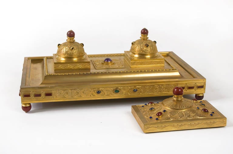 Gilded bronze Desk Set composed of a large inkwell and a paperweight both decorated with semi-precious stones such as emerald, amazonite, lapis lazuli, amethyst, labradorites, tiger's eye, agate and carnelian.

Engraved signature 'Otto Rohloff