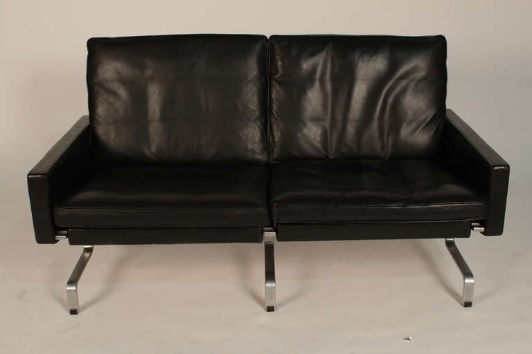Poul Kjaerholm PK31/2 two seater sofa in patinated black leather on chromed steel base. Loose cushions for seat and back, down-filled.
Edition E. Kold Christensen. Designed in 1958. Scandinavian modern.
Height: 30in. / 76cm. Length: 54in. / 137cm.