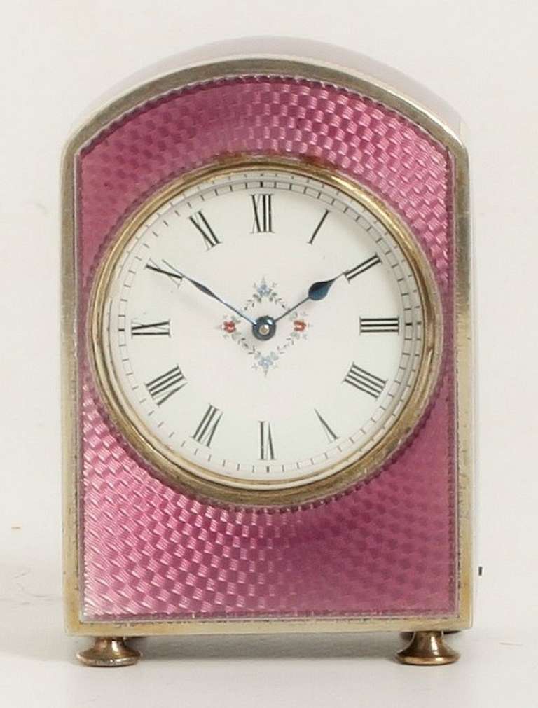 3.2-cm enamel dial with Roman numerals and central square flower garland, blued steel hands, 8-day spring driven movement with lever escapement and balance marked France Dèpose, arched silver case with purple guilloche transparant enamel panels,