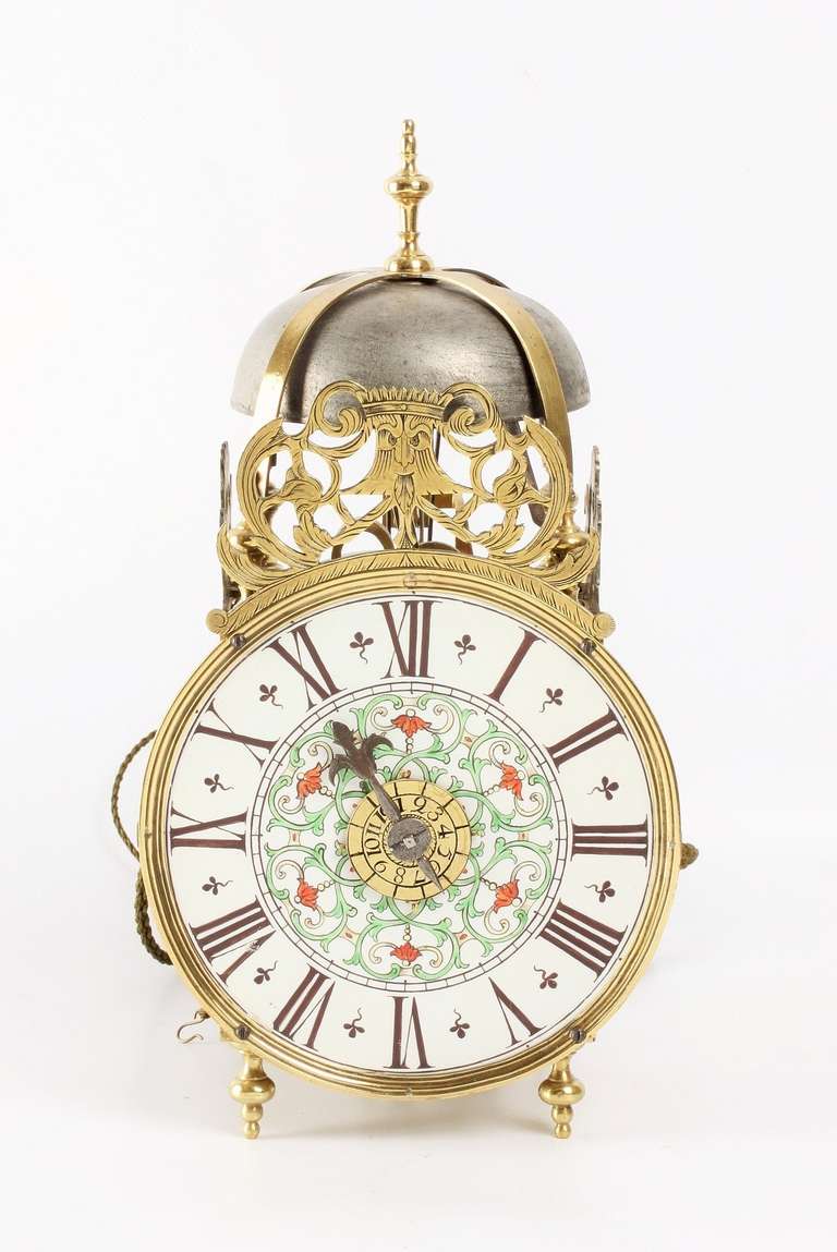 14-cm porcelain dial with Roman numerals, centre with green and red foliate scrolls and leaves, fine single iron hour hand and brass alarm disc, weight driven posted movement with silk suspended pendulum of 36-hour duration, countwheel half hour