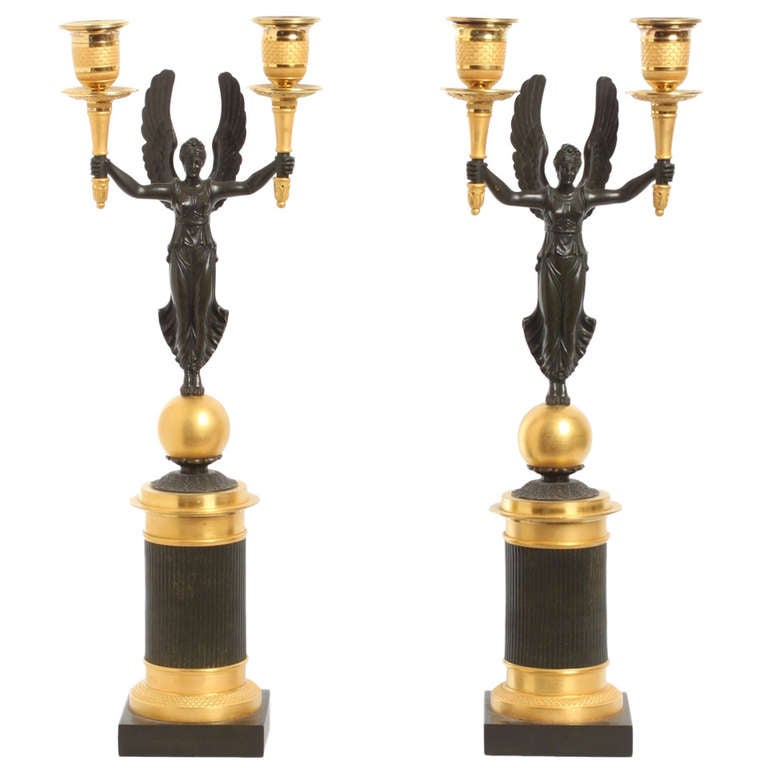 A pair of French gilt and patinated bronze 2-light  candelabra, circa 1830.