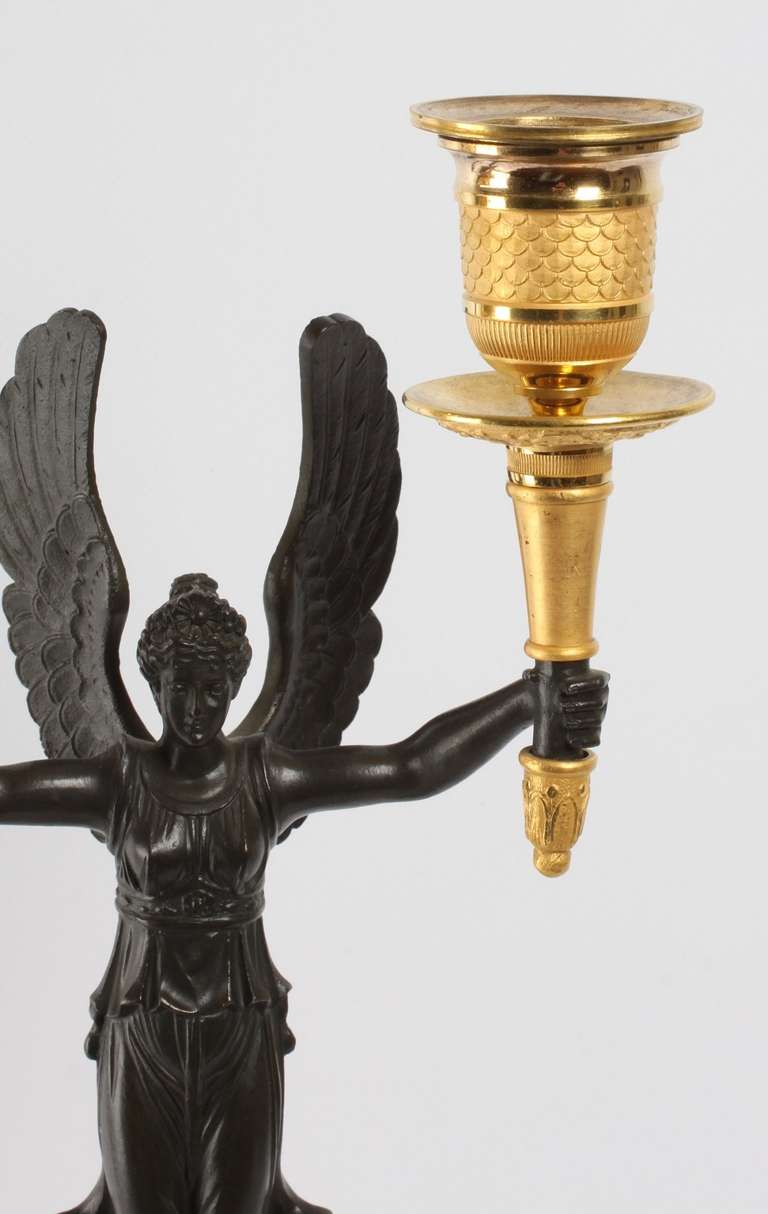 A pair of French gilt and patinated bronze 2-light  candelabra, circa 1830. 1