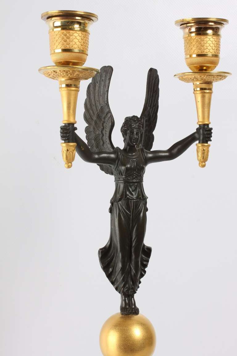 A pair of French gilt and patinated bronze 2-light  candelabra, circa 1830. 2