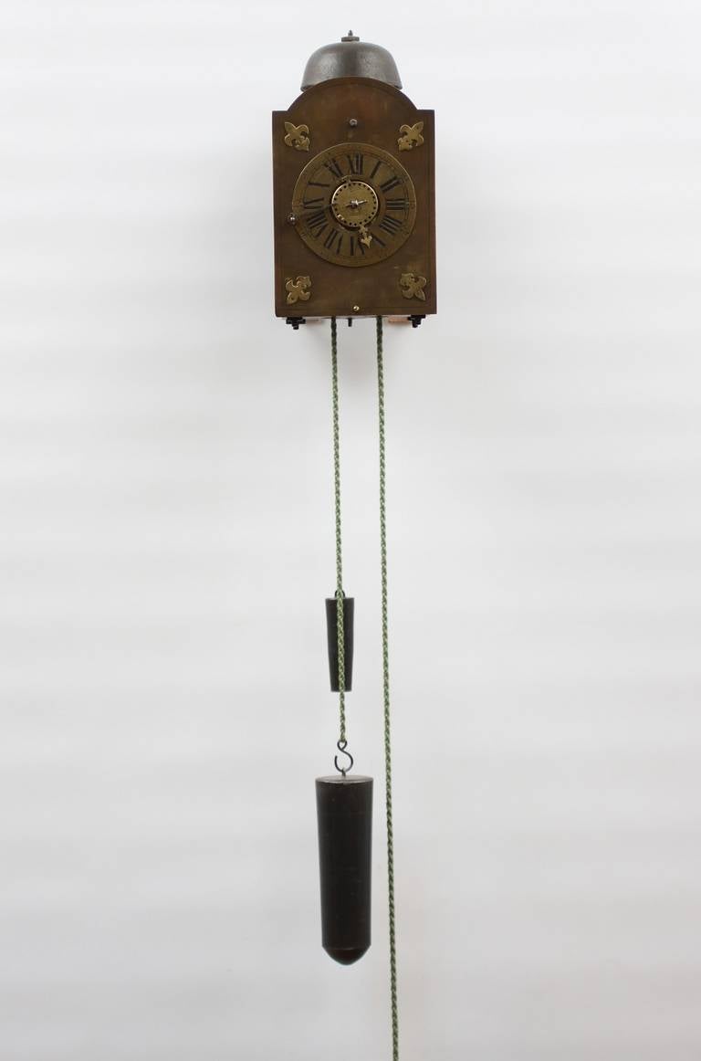 An Italian iron and brass wall alarm timepiece, circa 1740.