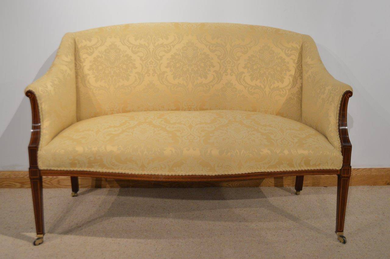 A Beautiful mahogany inlaid Edwardian Period antique settee/sofa. Having a shaped padded back newly re-upholstered in a gold silk damask, with shaped swept arms and a generous sprung seat of serpentine outline. The mahogany show frame made from