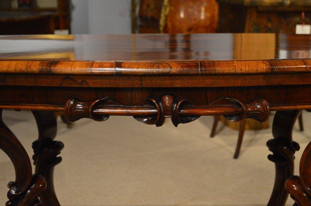 A good pair of rosewood Victorian Period antique fold over card tables. Each having a serpentine shaped top veneered in beautifully figured rosewood and turning to reveal storage for cards, counters ect. Opening to reveal a baize lined playing