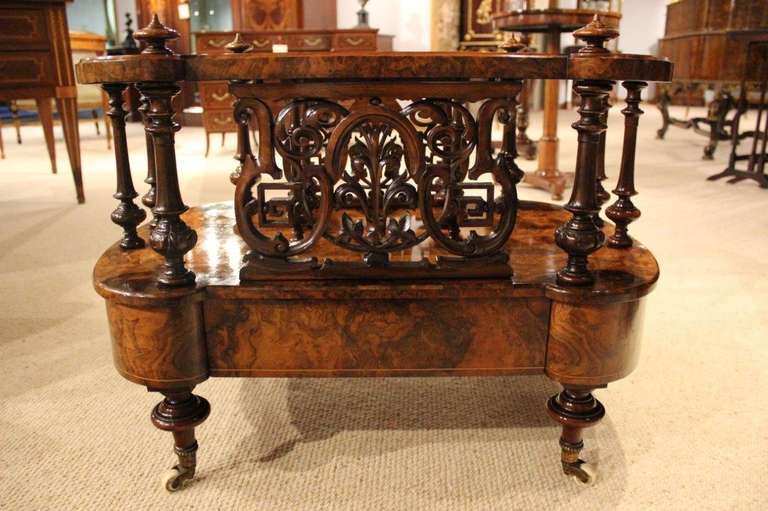 An exceptional large burr walnut Victorian Period antique Canterbury. Having a shaped frame veneered in beautifully figured burr walnut and with four walnut finials. The three internal divisions supported by turned walnut columns. The front and