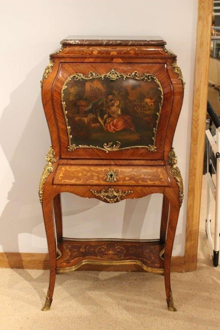 A French Louis XVI Style rosewood, marquetry & ormolu Vernis Martin escritoire. With a rectangular rouge marble top above the concave frieze with floral marquetry inlaid detail. Having a central rectangular door of bombe form with a Vernis Martin