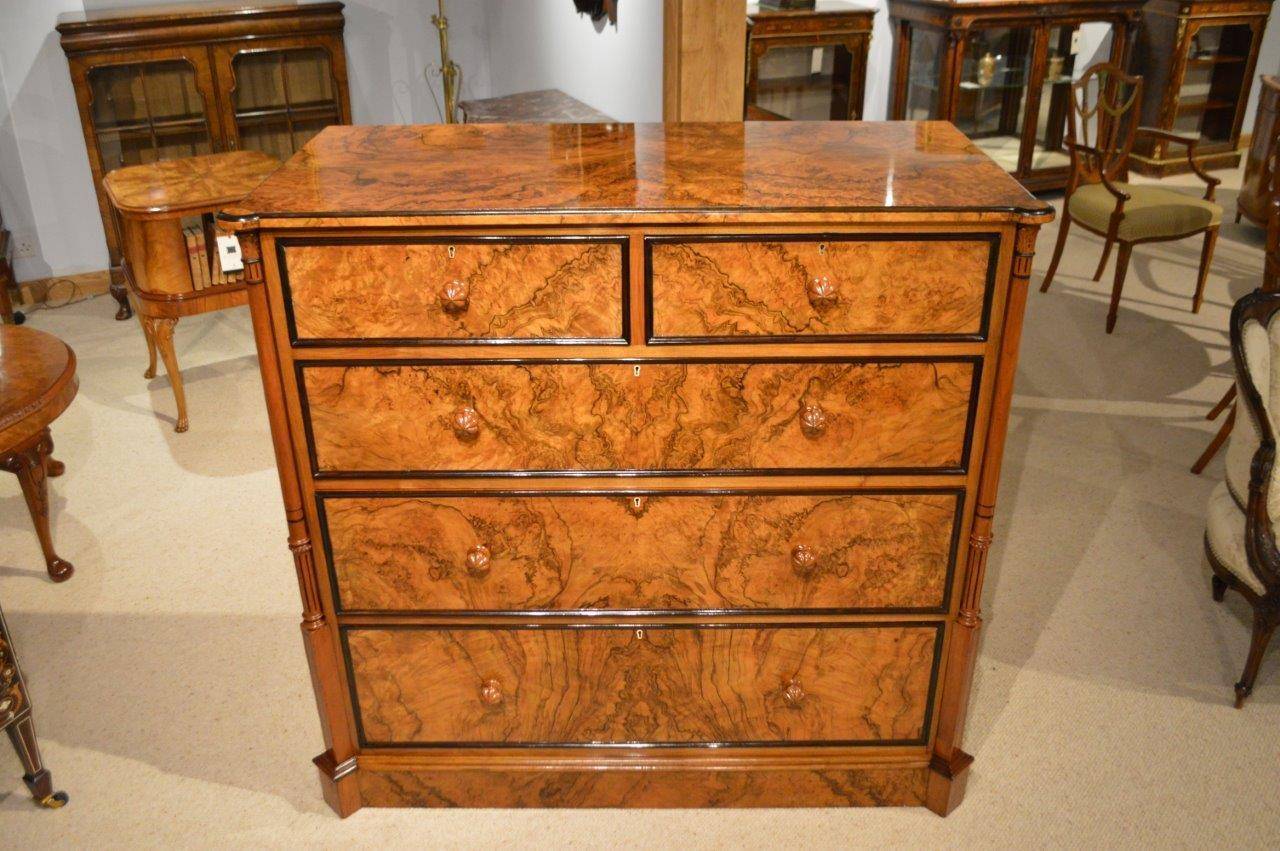 A burr walnut Stunning Victorian Period antique chest of drawers. The rectangular top veneered in choice burr walnut veneers and with an ebony moulded edge, above two short over three long mahogany lined drawers, each with stunning burr walnut