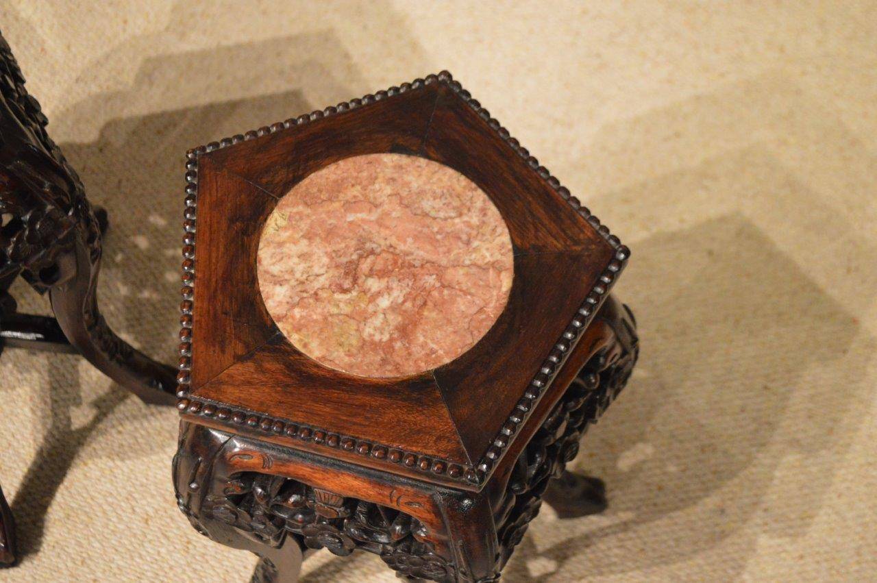 A small pair of hardwood Chinese marble inset stands. The pentagonal tops with circular inset rouge marble panels with a pierced fretwork frieze. Supported on cabriole legs united by cross stretchers. Chinese circa 1880-1900

Dimensions: 11