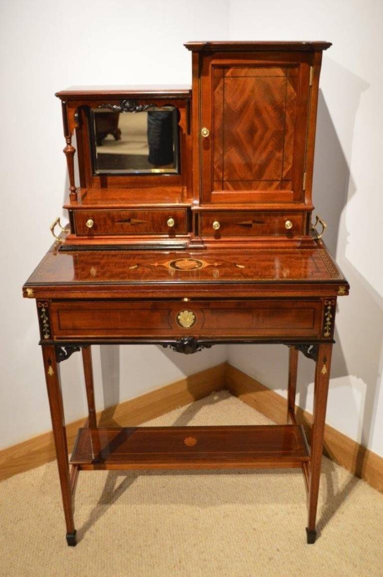 An unusual and rare mahogany inlaid Edwardian period writing table or cabinet. Having a removable upper section with a beautiful mahogany panelled door opening to reveal a beautifully fitted interior with pigeon holes, drawers and an arcaded