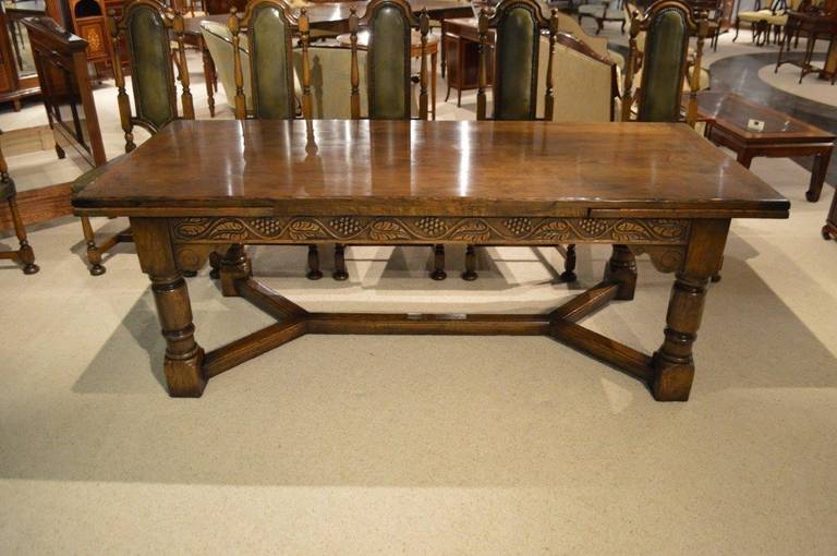 An Oak Jacobean Style Refectory Table And Set Of 12 Oak Dining Chairs. 1