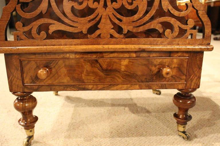 A burr walnut and walnut Victorian period antique canterbury. Having front and reverse pierced fretwork divisions, the internal divisions made from solid walnut and having bobbin turned supports. The base is veneered in beautifully figured burr