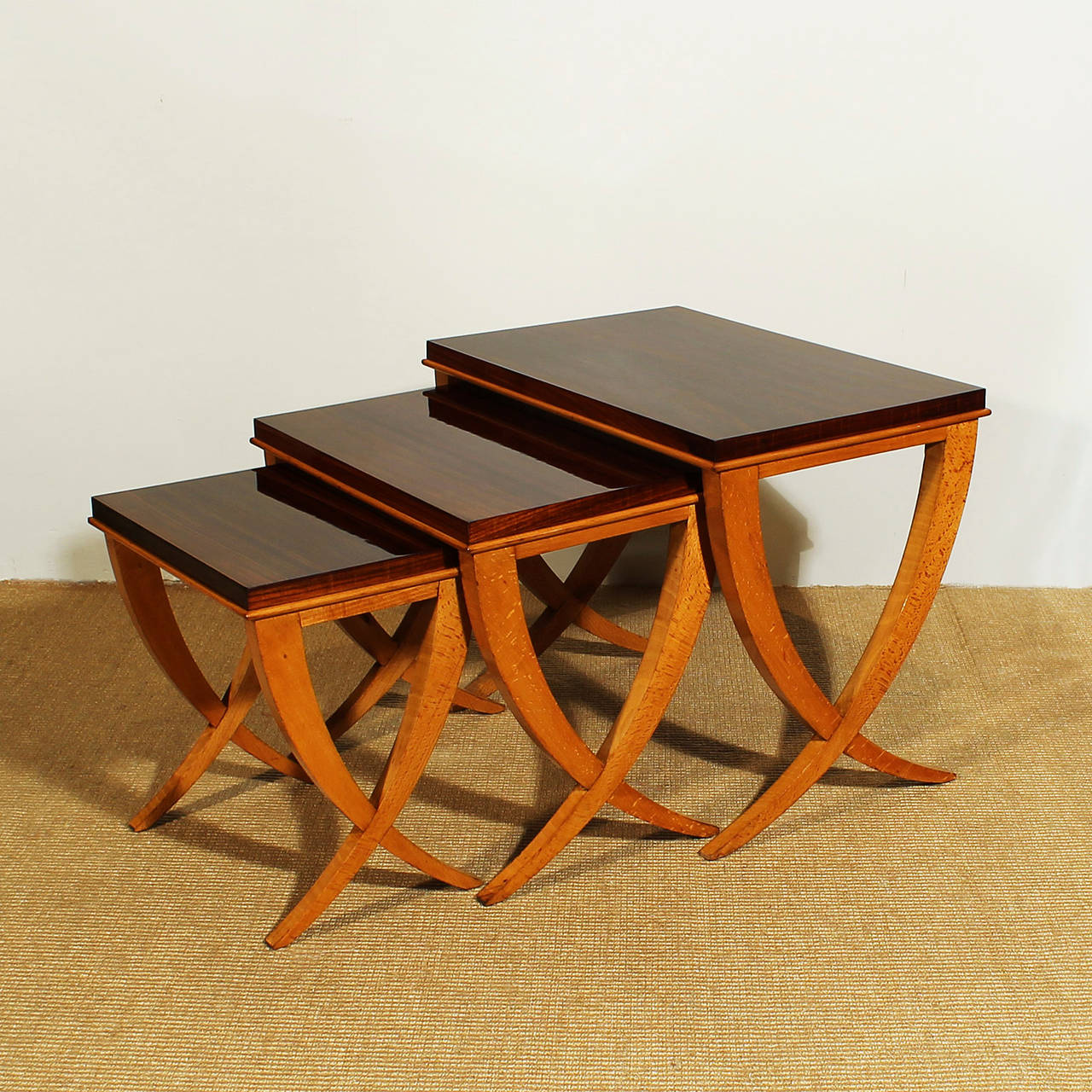 Beautiful nesting tables, 3 pieces, beech wood and rosewood veneer, french polish.
Design: De Coene
Belgium c. 1940

Big table: 40 x 60 x 49 cm
Medium table: 34 x 50 x 44 cm
Small table: 28 x 40 x 40 cm