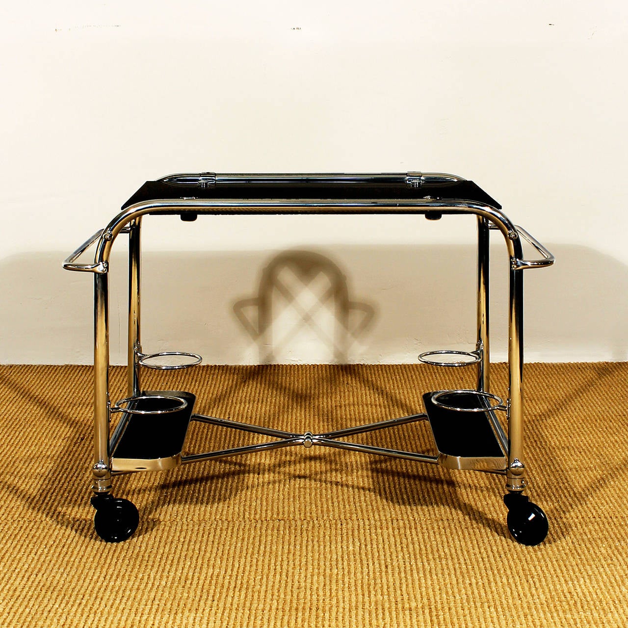Art Deco bar cart, chrome plated metal and black opaline on top.
France c. 1930