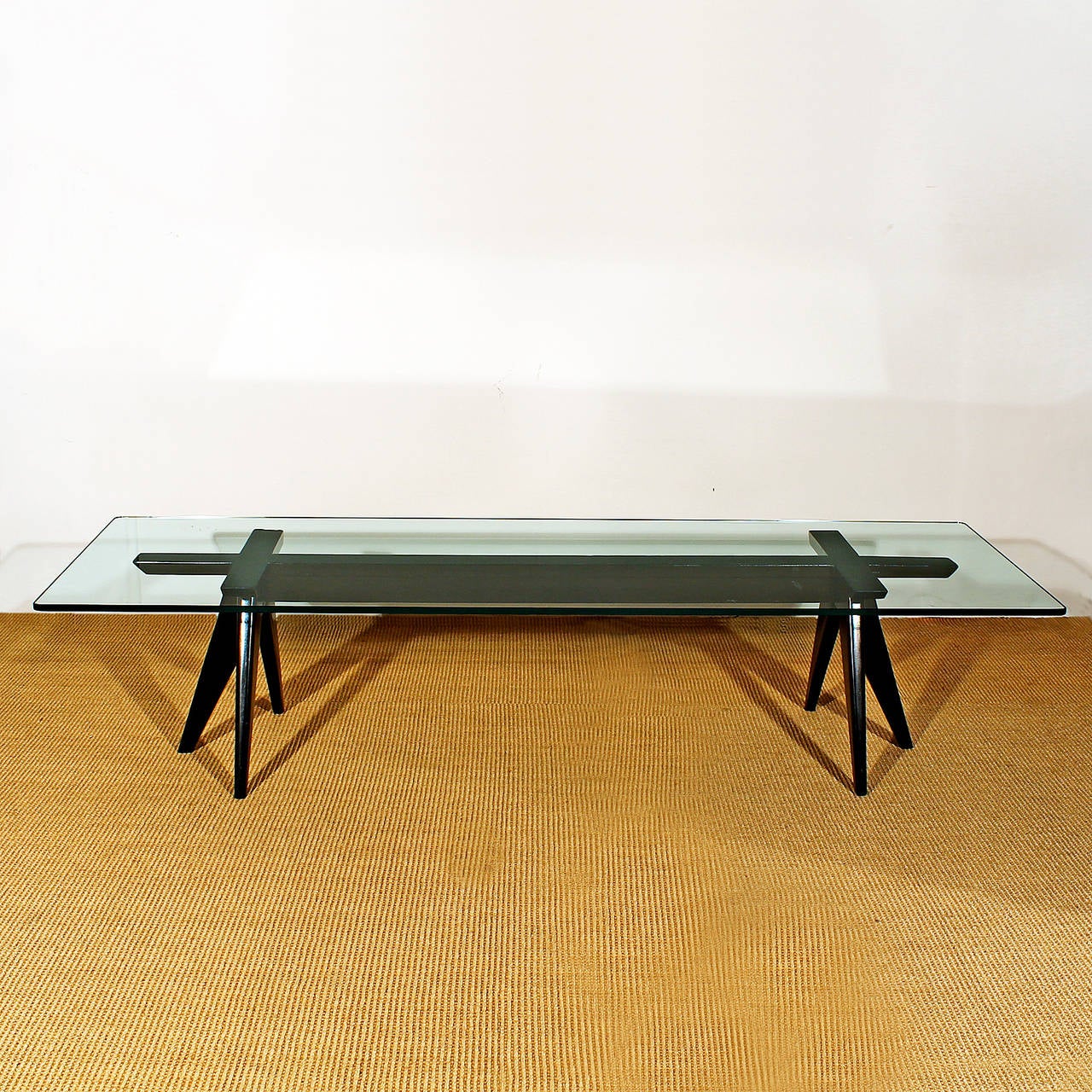 Large coffee table, black stained beechwood structure, French polish, original thick glass on top.
Italy, circa 1950.