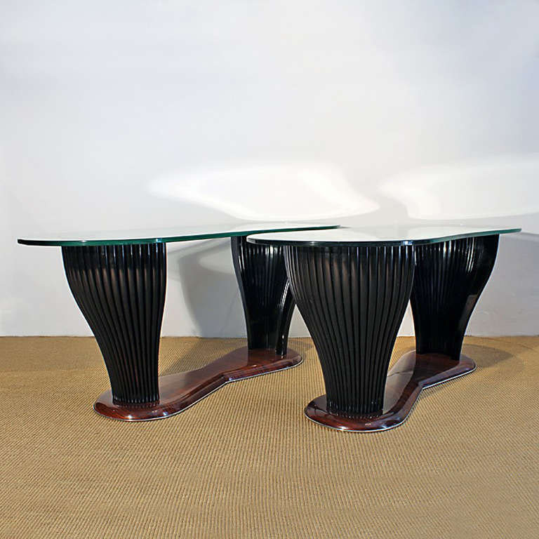 Two coffee tables, mahogany and rosewood veneer, base with nickel plated brass decoration, thick engraved and partially silver plated glass on top.
Design: Vittorio Dassi