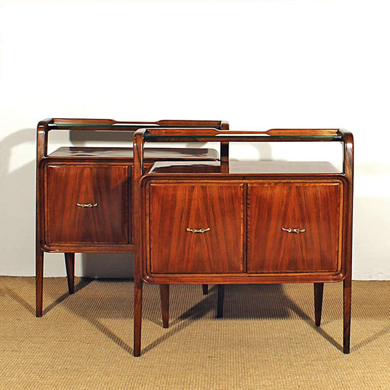 Exceptional pair of large bedside tables, solid walnut and walnut veneer, french polish, glass shelf, brass handles.
Italy c. 1940