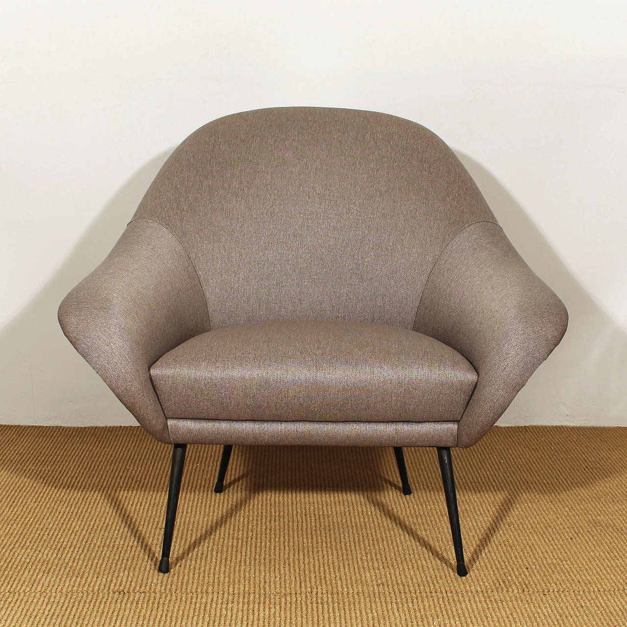 Pair of small rounded armchairs completely restored, heathered gray fabric upholstery, black lacquered metal feet.

Italy, circa 1950