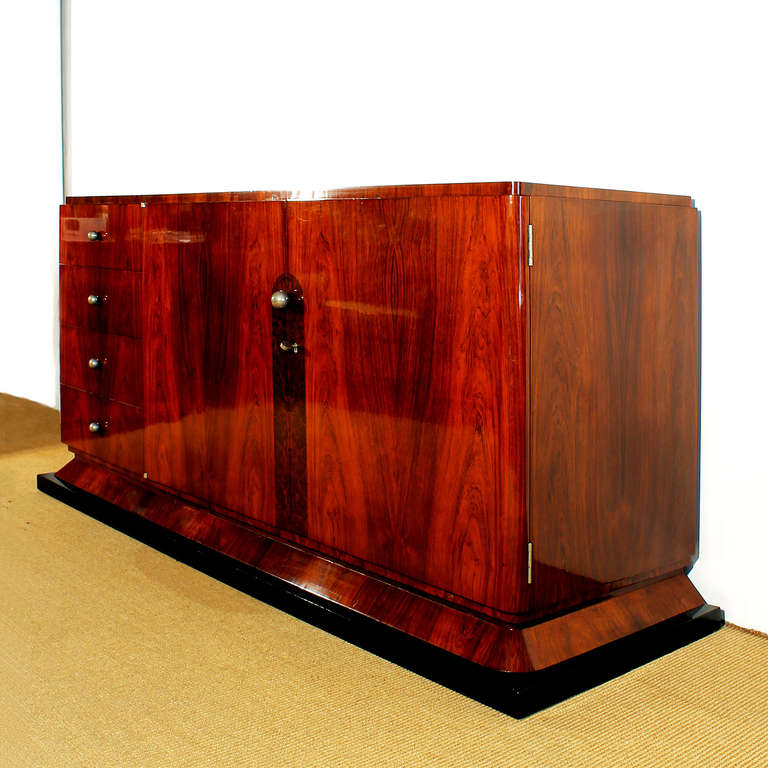 Art deco sideboard, oak structure and Rio rosewood veneer, 2 doors and 4 drawers, nickel plated balls handles, shelves inside, 3 drawers with individual close system.
France 1930´s