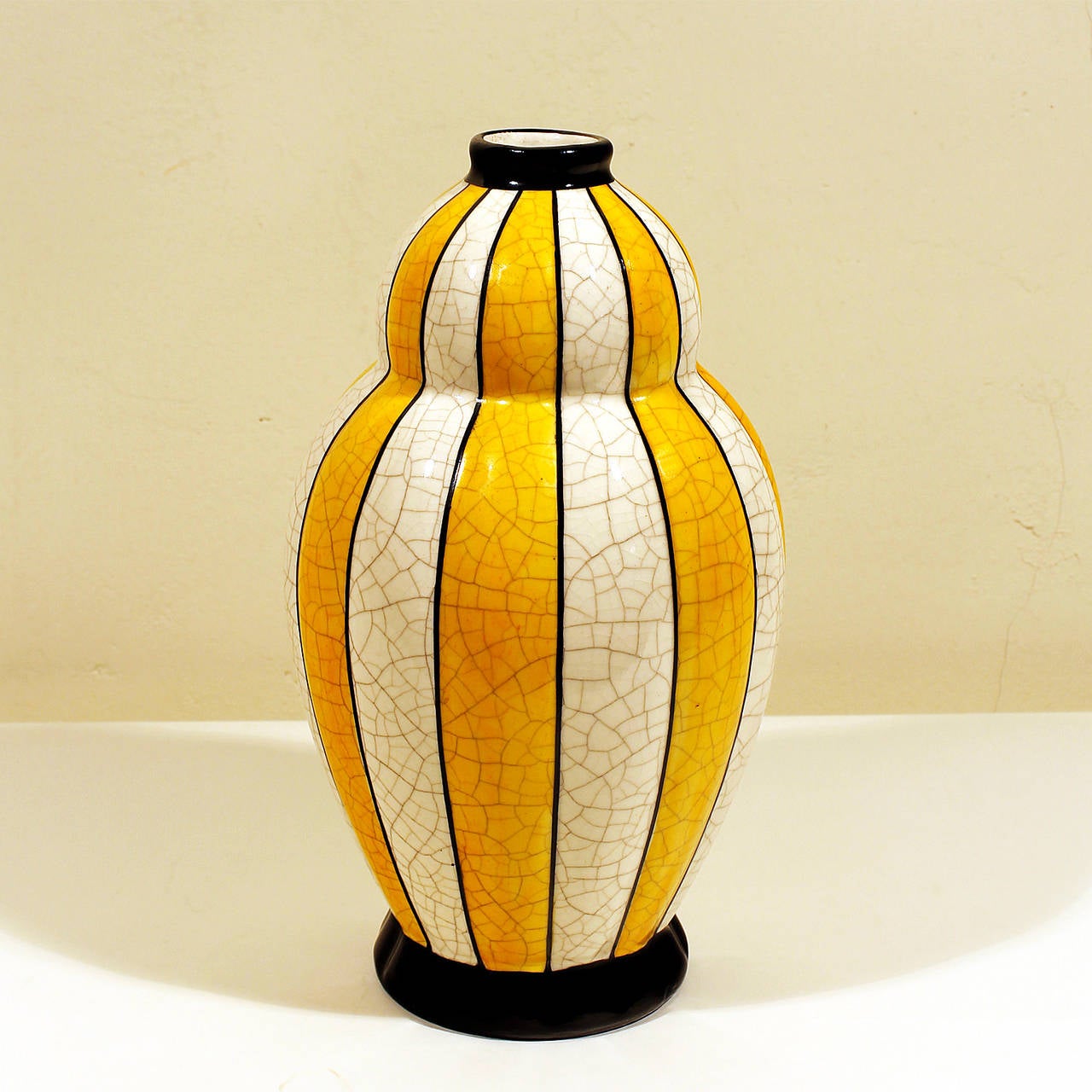 Two Art Deco ceramic vases, stripes in white and two nice and different shades of yellow crackled enamel (one vase is darker yellow and the other one lighter yellow)
Numbered in the base: 146 in both vases.
Design: Charles Catteau.
Manufacturer: