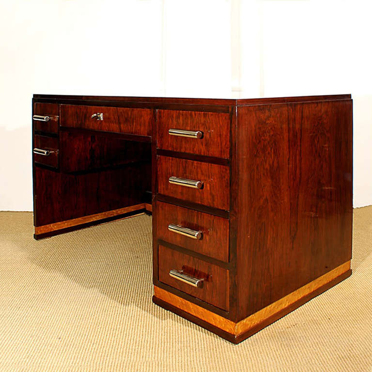 Splendid Art Deco cubist and central desk, seven drawers in the front side, mahogany structure, Rio rosewood veneer, mottled maple baseboard all around, French polished, nickel plated brass handles, high quality. France, circa 1930.