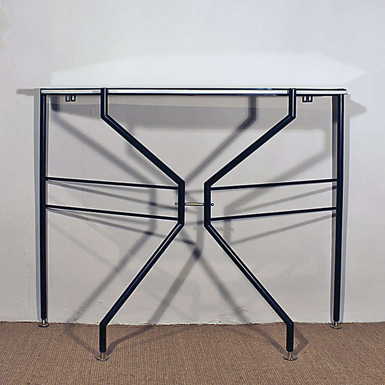 Black lacquered steel console, brass feet, white vinyl covered wood with glass on top.<br />
Italy circa 1960