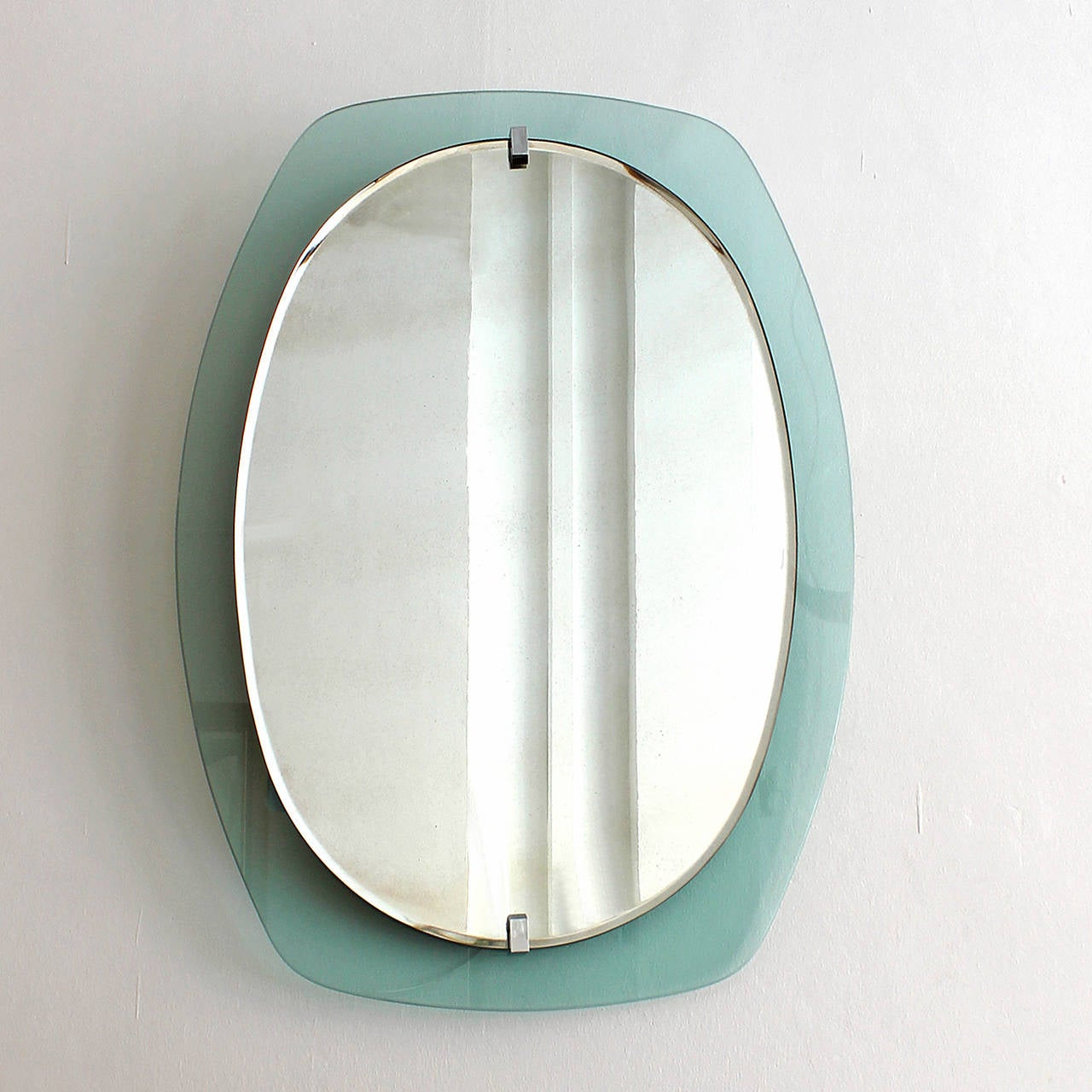 Mirror with a light green glass frame, holded by chrome plated hooks, original mirror with its original patina.
Brand: Veca

Italy c. 1960