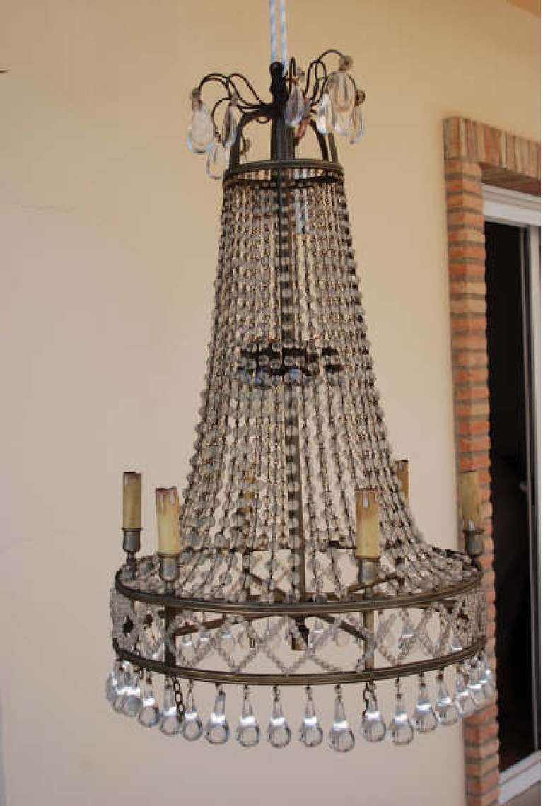 A magnificent large bronze chandelier with crystal drops.