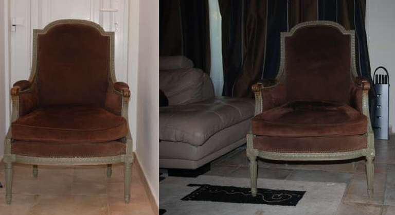 Excellent period pair of bergere chairs. Carved wood frames painted grey, upholstered in chocolate brown, rubbed buffalo hide ( not quite suede)