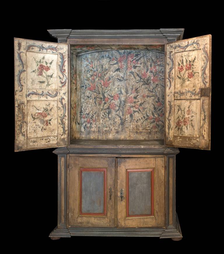 A rustic Portuguese cabinet with painted flowers on the upper inside