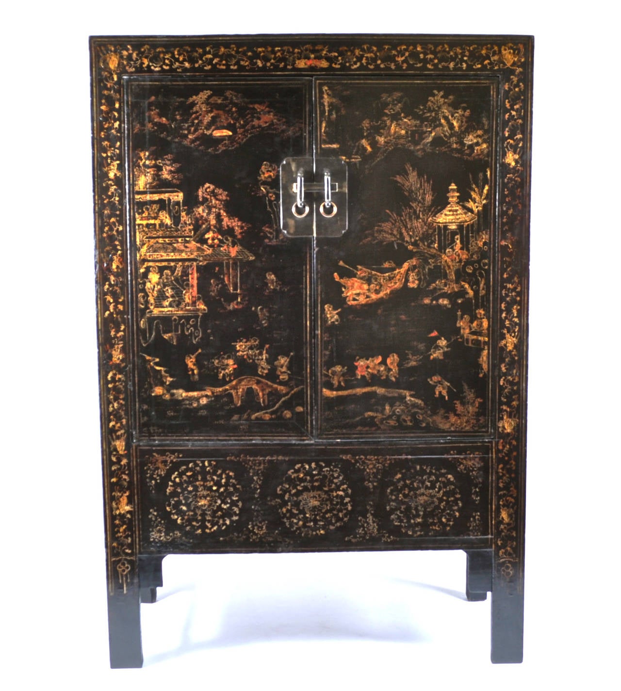 For sale on 1stdibs a 19th Century Chinese Gilt Lacquered Cabinet with Two Doors on vertical feet. The chinoiserie landscapes depicting outside scenes on black and gilt lacquer. It has two shelfs on the on the interior which makes it a great piece