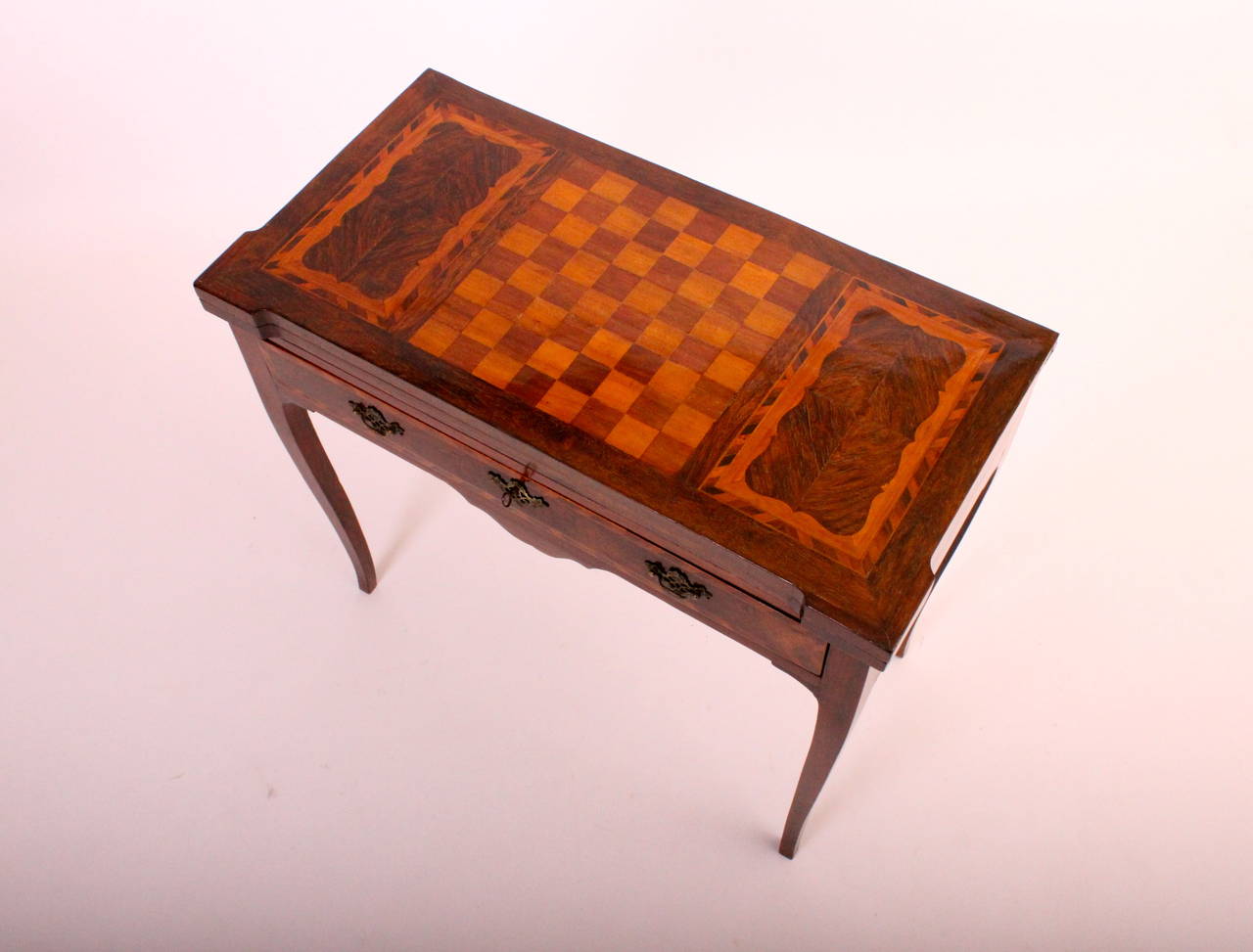 With a box wood and other woods inlaid top showing a chess board that opens to a card table. 
D. Maria I Period table (Queen of Portugal, 1777-1816).