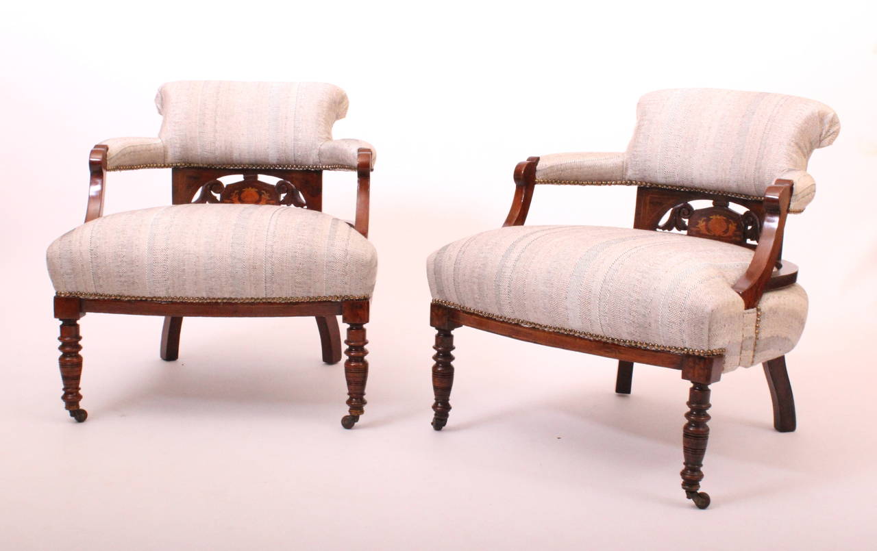 Pair of rosewood 19th century English tub chairs on castors. 
New upholstery.