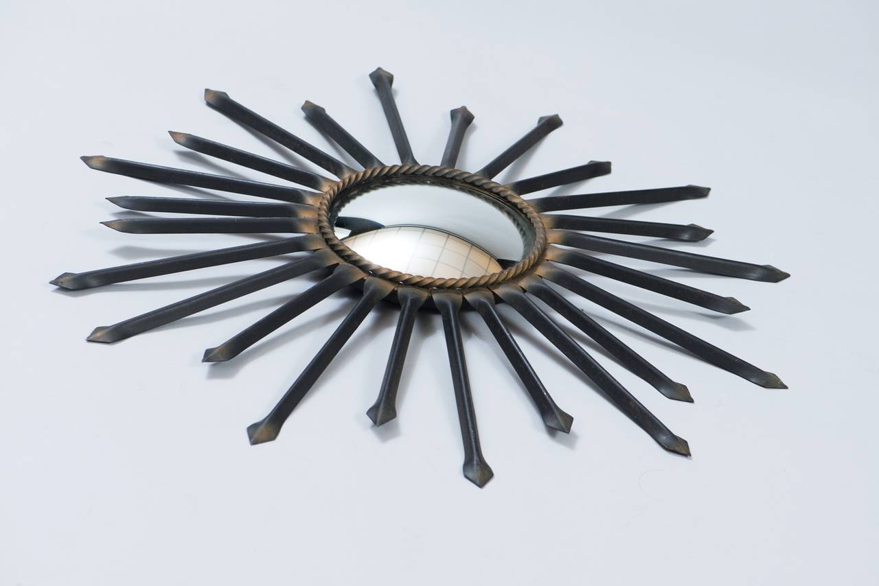 Metal sunburst mirror with convex mirror.