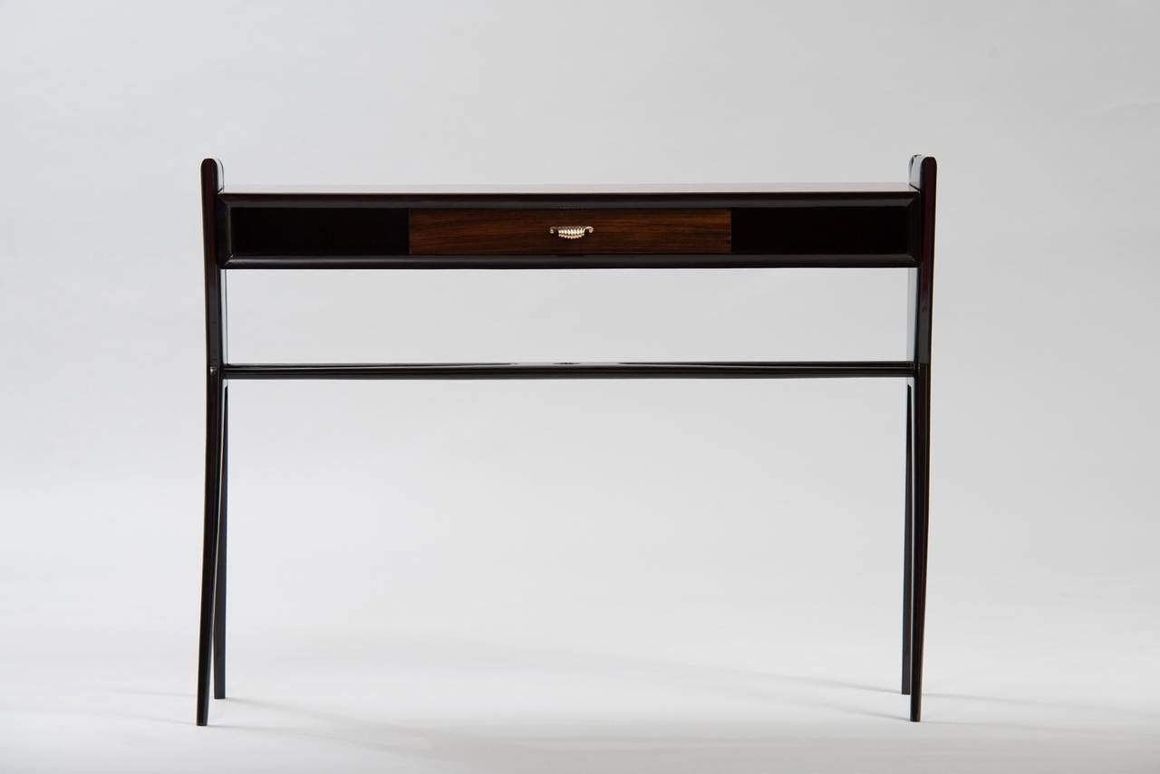 Rosewood, ebonized wood, painted glass and brass console.