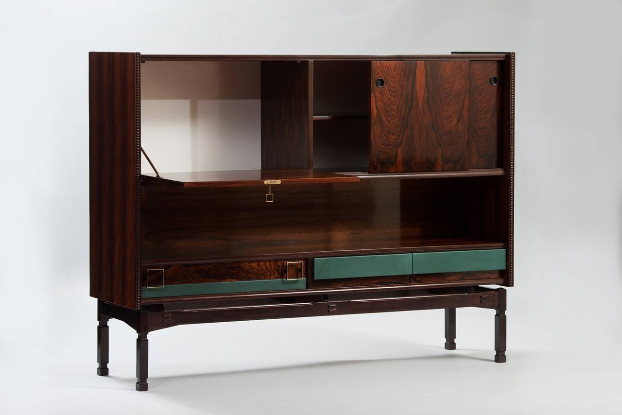 Rosewood highboard with drop-front bar, drawers upholstered in green faux leather and brass hardware.