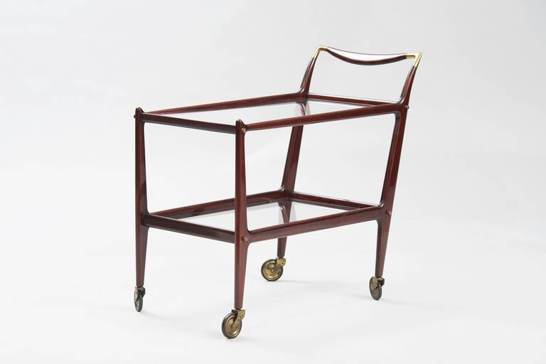 Delicate bar cart, wood frame, glass and brass.
Producer: de Baggis.