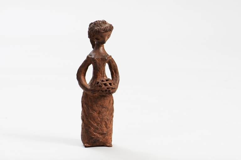 Gracious sculpture in terracotta, representing a young girl with a basket.
This piece is signed but we cannot understand the name.