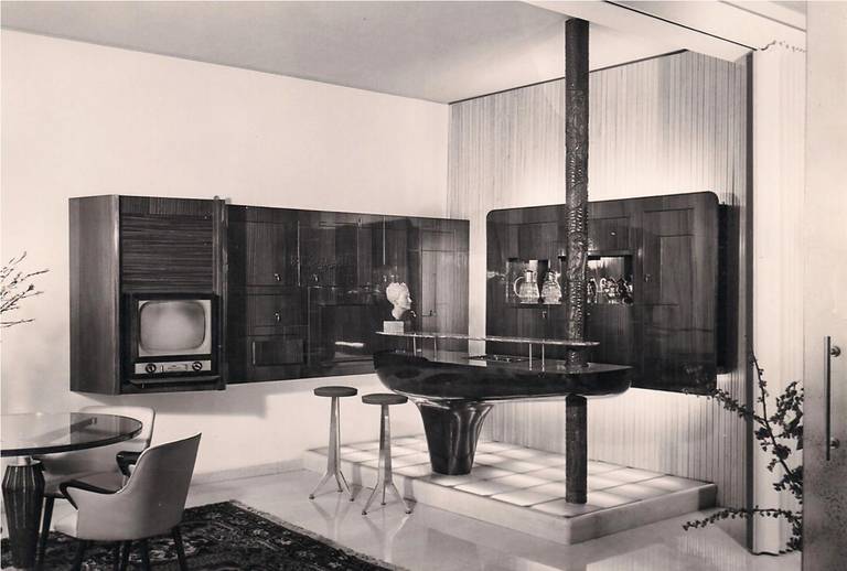 Exceptional large wall-mounted bar attributed to Osvaldo Borsani.
The black and white photos were taken in the house where it was originally, in the image you can see the chairs by Osvaldo Borsani so we think that the wall-mounted bar is probably