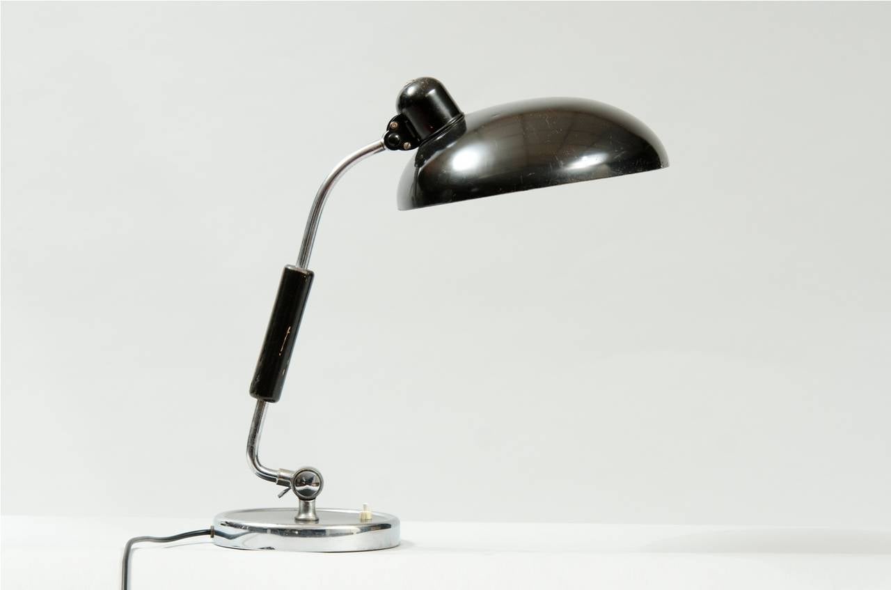 Black lacquered adjustable desk lamp.