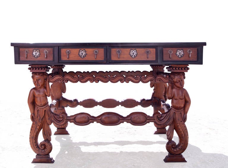 Indo-Portuguese hall table
Teak with ebony inlay, cast iron mounts
With 8 drawers and 4 aparent drawers. Legs carved in the shape of mermaids (naginis).
1,30 m long
17th century

Indo-portuguese furniture. These pieces are a result of the