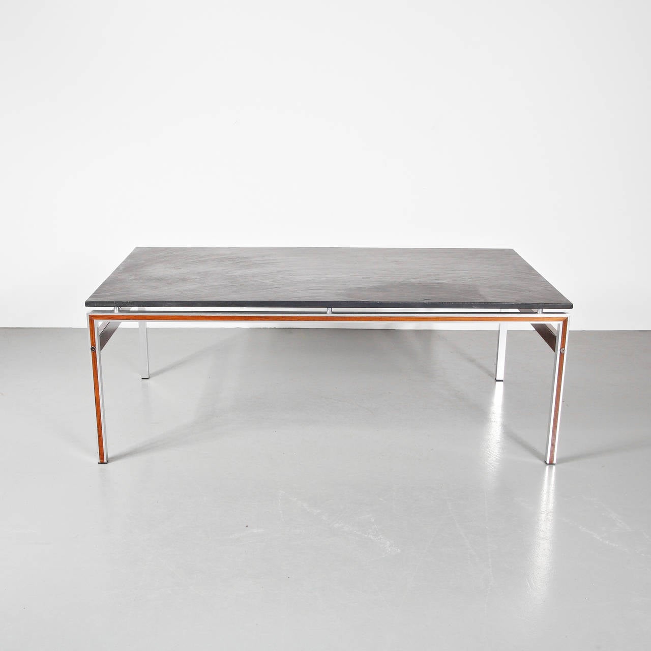 Stunning coffee table with slate stone top, manufactured in Denmark around 1960.

This eye-catching piece has a beautifuly crafted wooden with chrome metal base and a slate stone top of the highest quality. It has a very unique appearance and