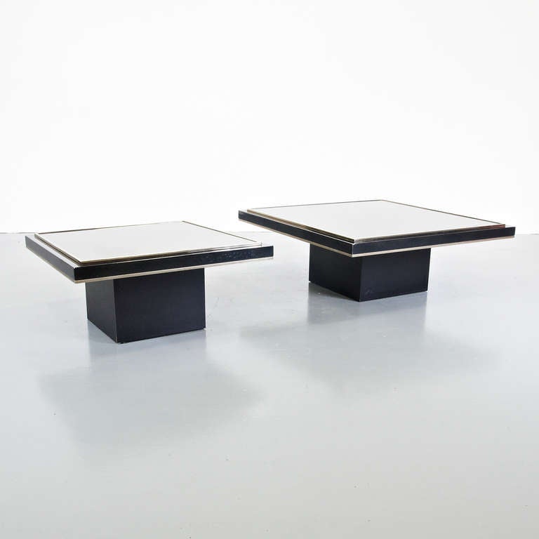 Pair of coffee tables in two different sizes designed by Roger Vanhevel.

Black Chrome base with 23 carat gold details and a glass top.

In good original condition, with minor wear consistent with age and use, preserving a beautiful patina.