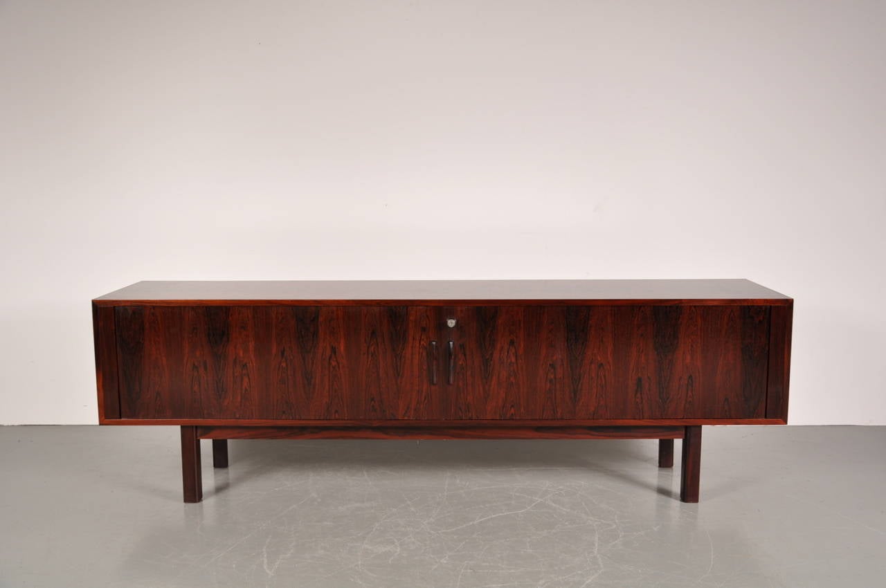 Beautiful large sideboard by Arne Vodder for Sibast Denmark, manufactured around 1960.

It is made of high quality rosewood with smooth sliding doors and several shelves, all in complete original condition. The back is also very nicely finished,