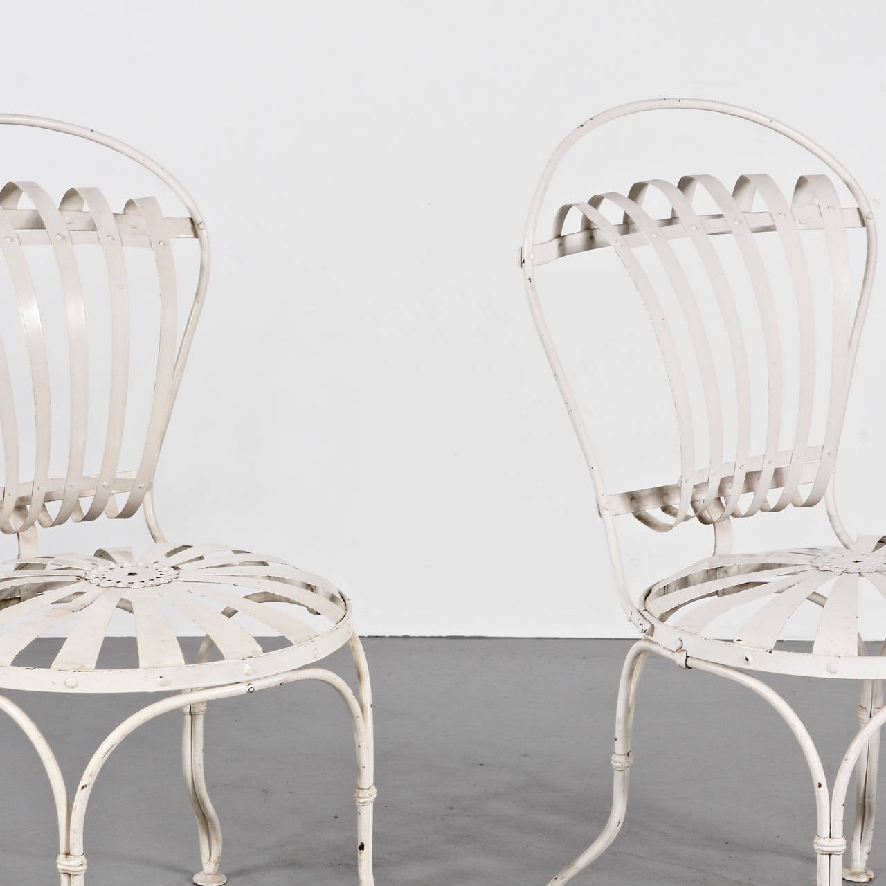 Pair of Francois Carre garden chairs manufactured, circa 1930 in France.
Metal legs and structure, metal seat and backrest.

In good vintage condition with minor wear consistent with a age and use, preserving a beautiful patina.

This model of