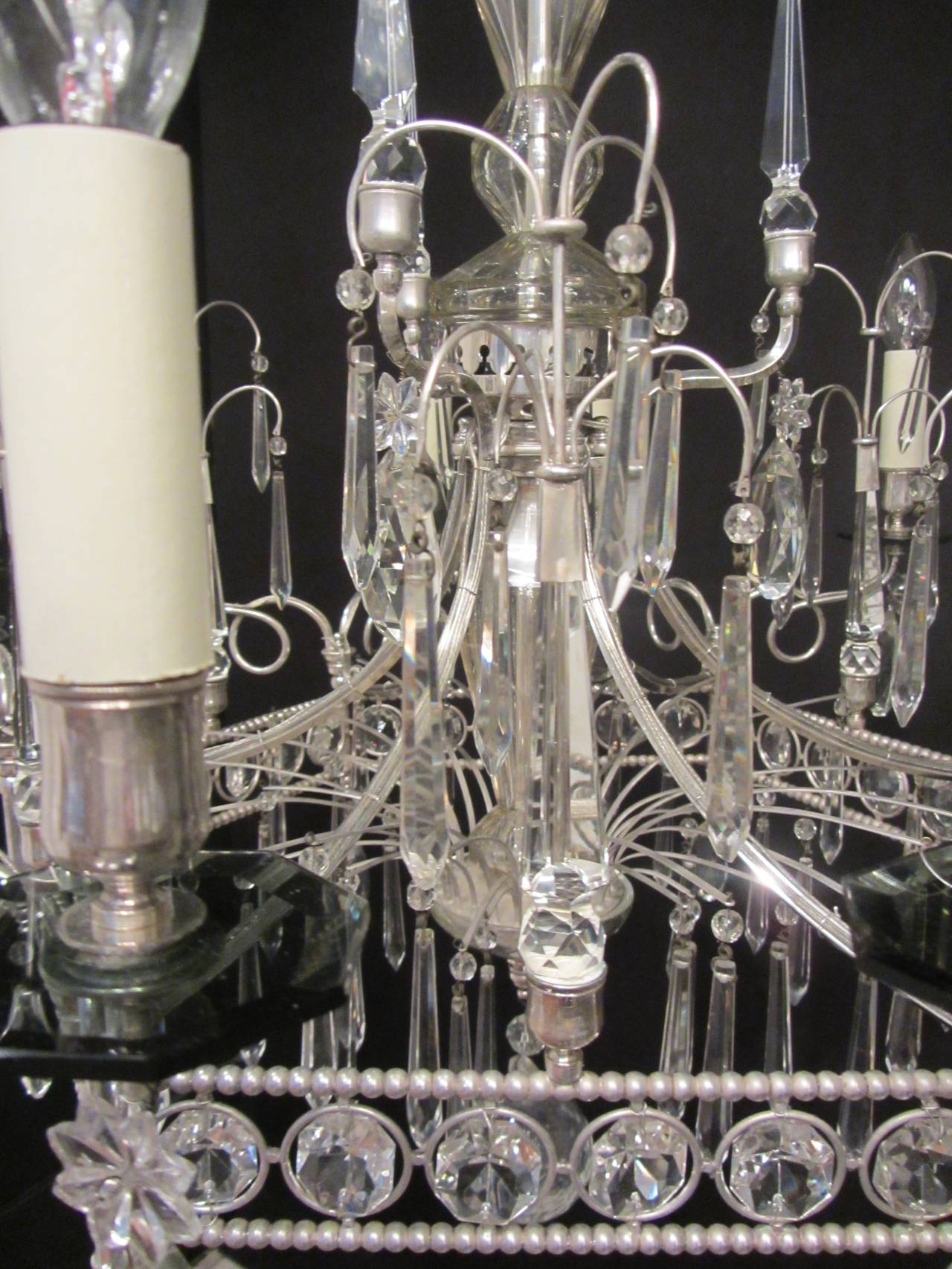 A twelve-armed silver plated brass and crystal pentagonal chandelier of unusual design, with a fountain like structure and cut-glass drops. Possibly Baltic, circa 1880.