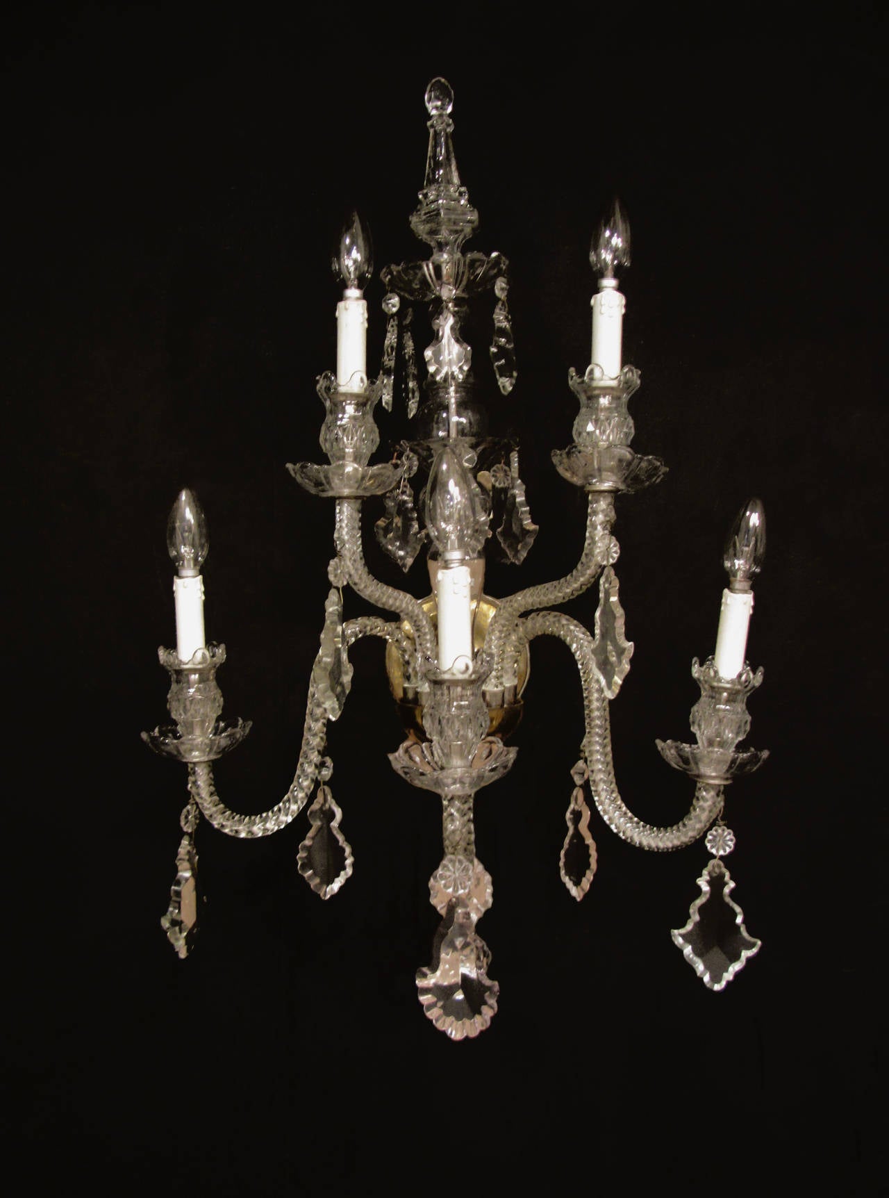 A pair of fine cut-glass, five-arm Victorian wall lights. The scrolling arms are arranged over two levels with cut-glass plaques, drip pans and a fine cut-glass finial at the top.